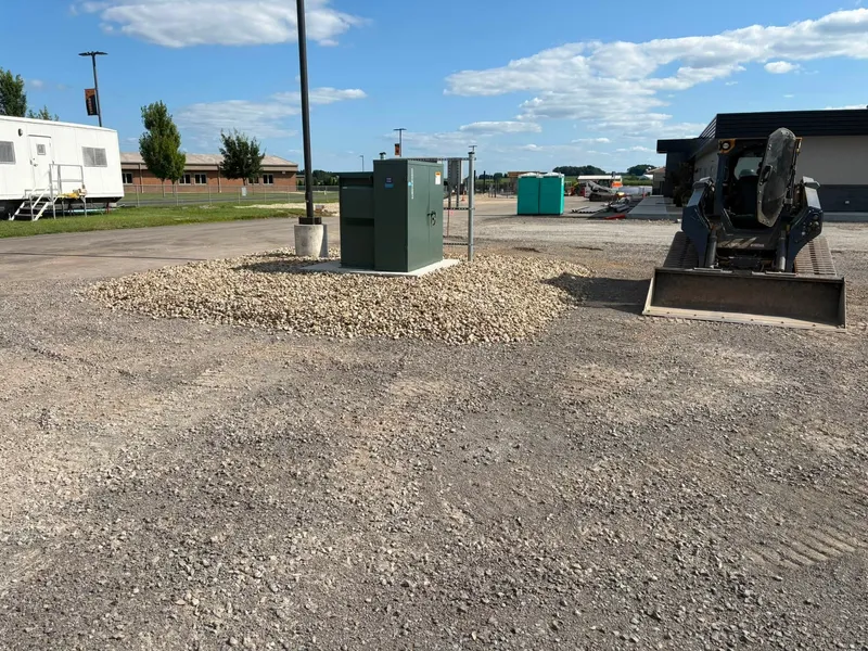 Stone pad around utility equipment on a school site