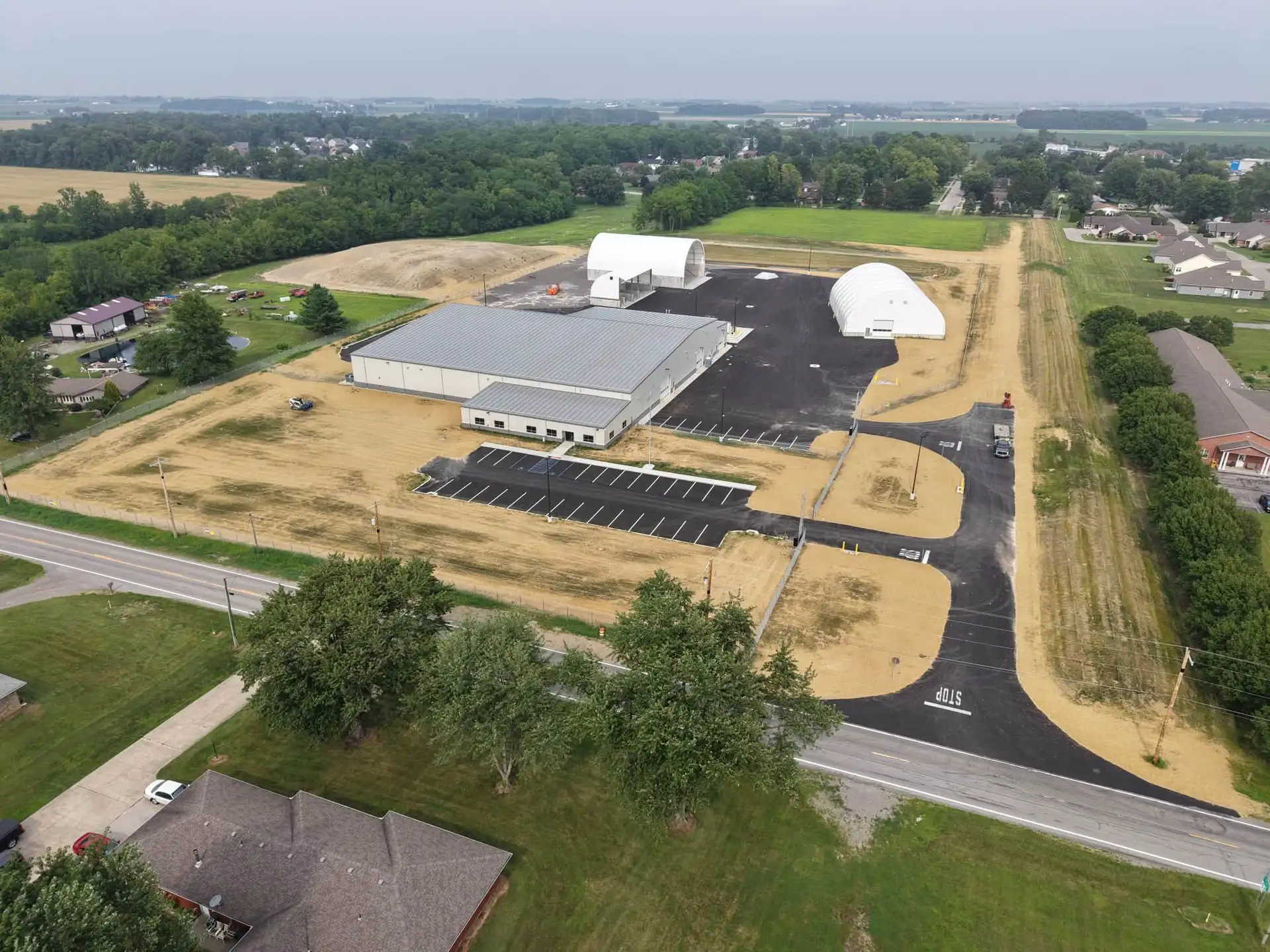 Aerial view of a commercial development with graded and seeded grounds