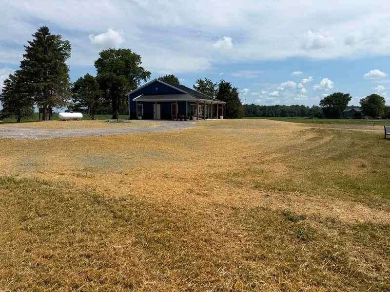 Graded and seeded acreage around a new home and pond