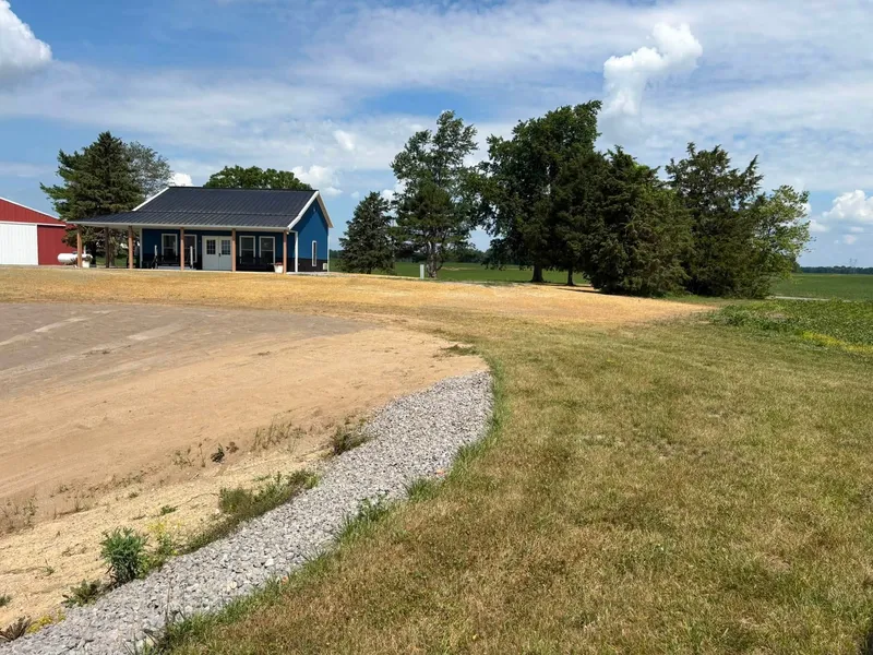New pond with a stone shoreline and graded, strawed banks